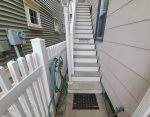 Stairs to door and outdoor hose